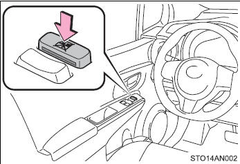 Press the switch down to lock the passenger window switches.