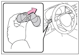 Headlight lever operation for temporarily selecting low beams
