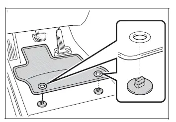 Inserting Toyota RAV4 floor mat retaining hooks through the mat eyelets