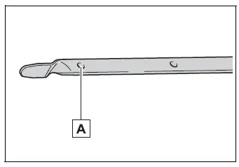 Engine oil dipstick showing the low-level mark