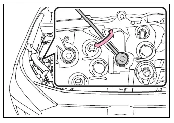 Headlight adjustment bolt B being turned to match bolt A
