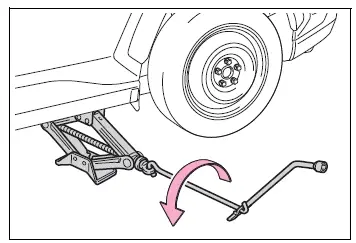Vehicle being lowered carefully after the spare tire is installed