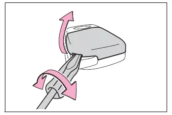 Flathead screwdriver removing the wireless remote control key cover