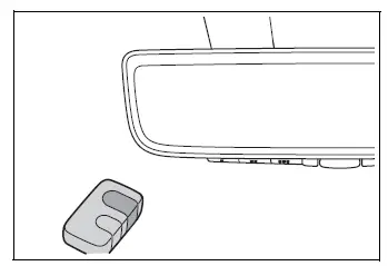 Remote control transmitter positioned near the Toyota RAV4 HomeLink buttons