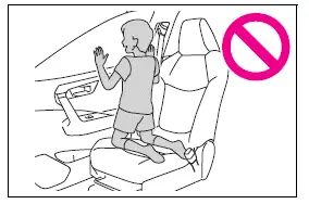 Unsafe kneeling position near a side airbag and open window