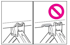Tire jack correctly positioned beneath the designated vehicle jack point