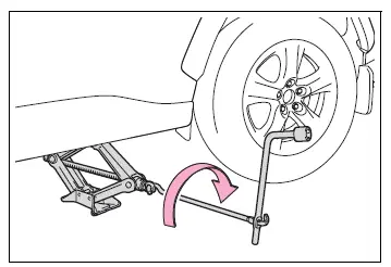 Vehicle raised until the flat tire is slightly above the ground