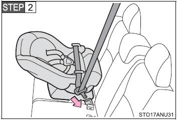 Run the seat belt through the child restraint system and insert the plate into