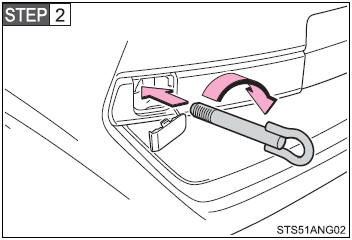 Insert the towing eyelet into the hole and tighten partially by hand.