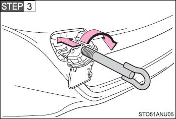 Insert the towing eyelet into the hole and tighten partially by hand.