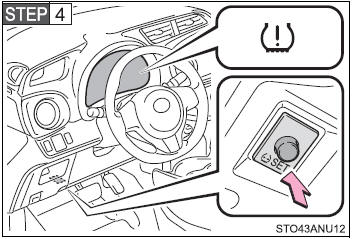 Press and hold the tire pressure warning reset switch until the tire pressure