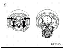 2. Release the bulb retaining spring and remove the bulb. Install a new bulb