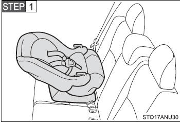 Place the child restraint system on the rear seat facing the rear of the vehicle.