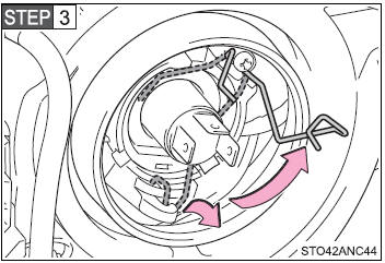 Release the bulb retaining spring.