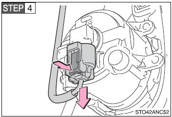 Unplug the connector while depressing the lock release.